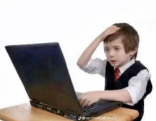 A confused child looking at a laptop